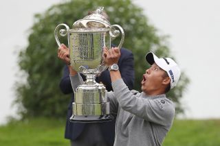 Collin Morikawa reacts to dropping the Wanamaker Trophy lid