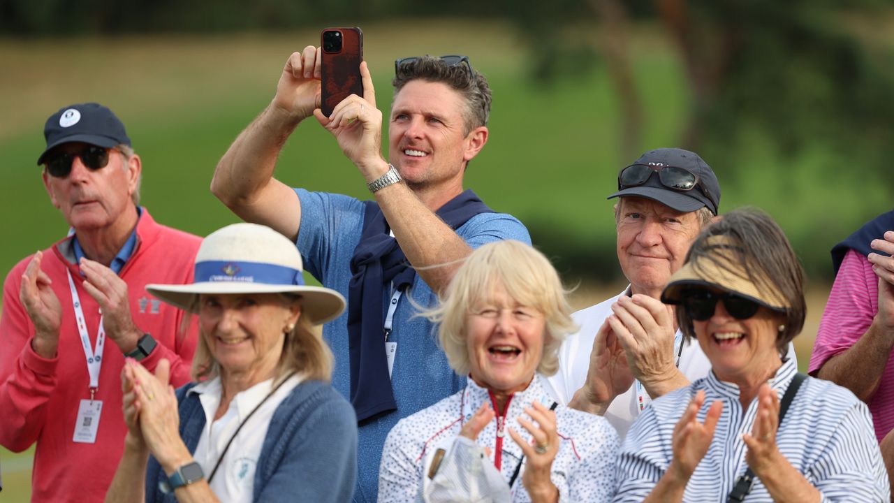 Justin Rose takes a photo in the crowd at the Curtis Cup