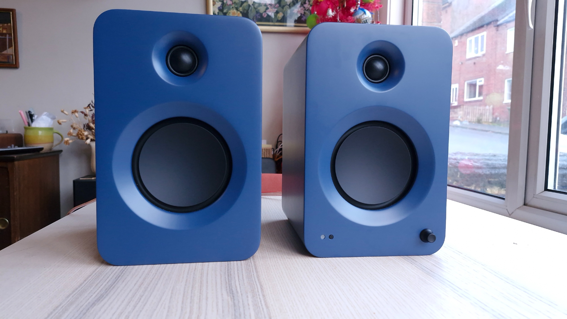 Kanto Ren speakers on a pine table