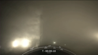 The Falcon 9 on the pad, shrouded in fog, 10 seconds before liftoff.