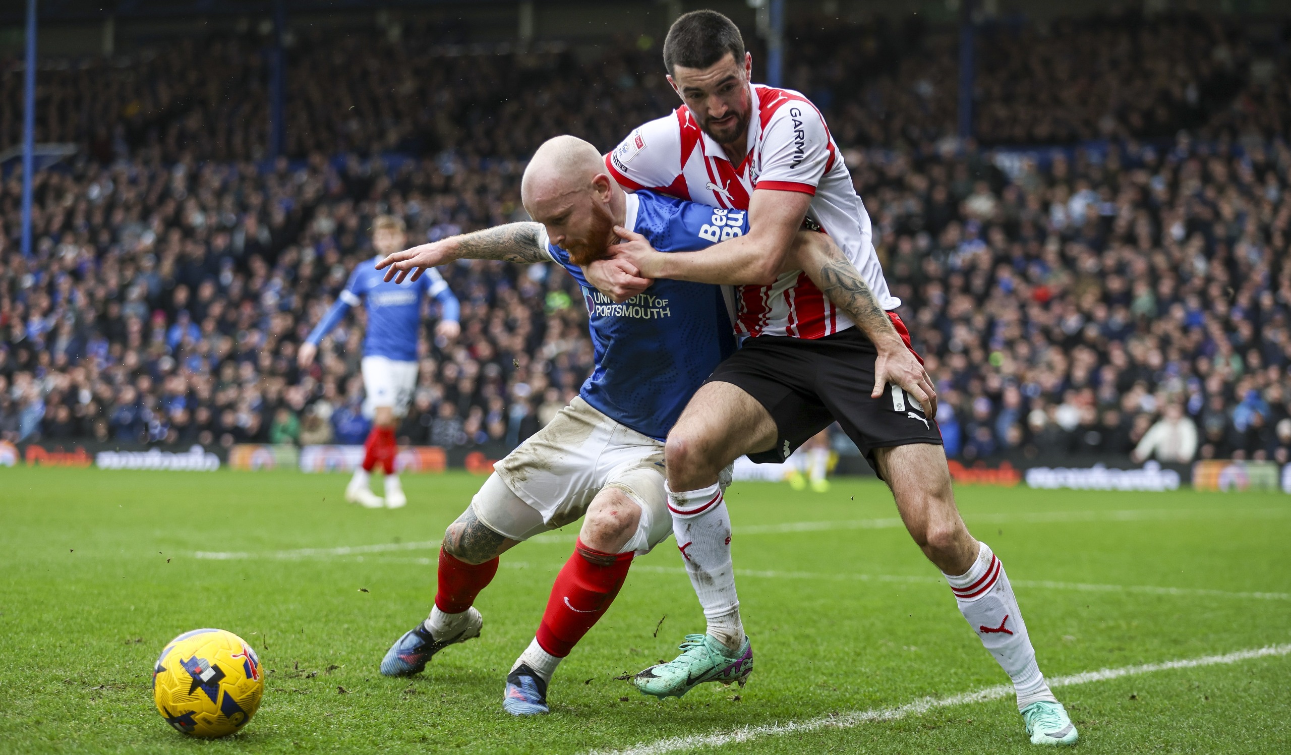 Connor Ogilvie of Portsmouth and Finn Azaz of Southampton get to grips with each other during the Sky Bet Championship match at Fratton Park on January 25, 2026 in Portsmouth, England