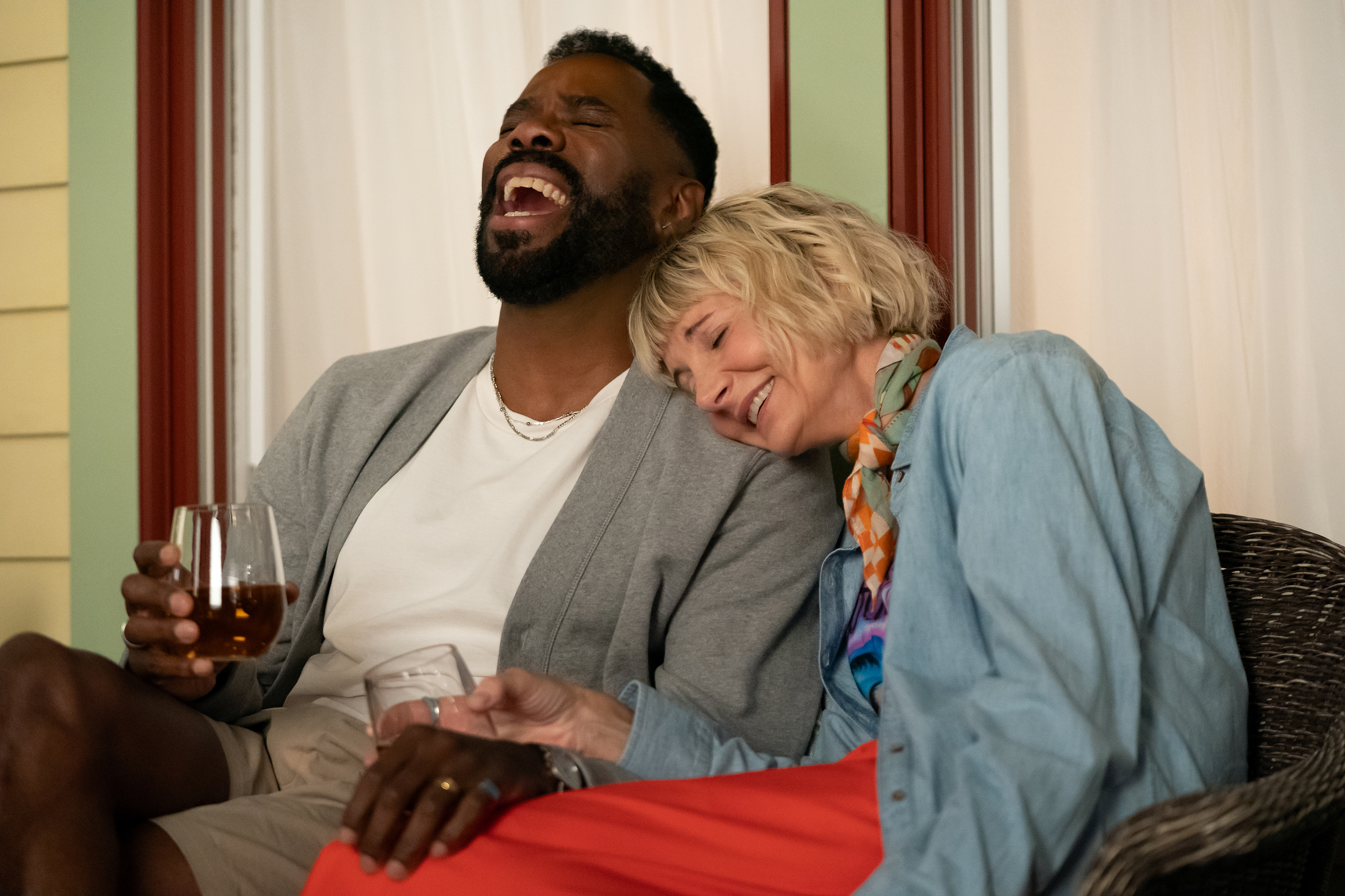 colman Domingo as Danny and Kerri Kenney-Silver as Anne drinking wine and laughing on a front porch in the four seasons season 2