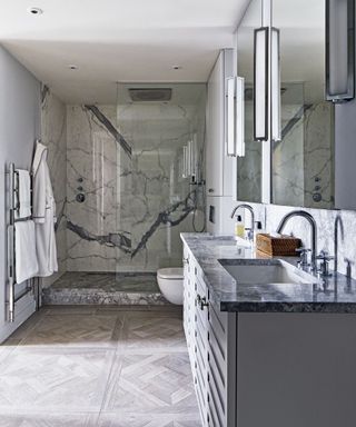 Gray bathroom with parquet floor and marble wall