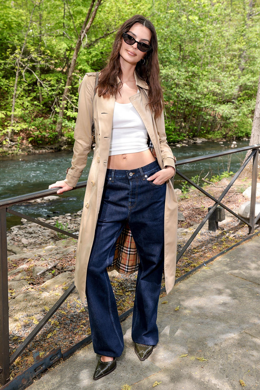 Emily Ratajkowski wearing a trench coat and white tank top.
