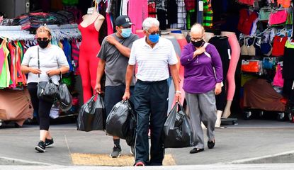 People wear face masks while shopping in Los Angeles.