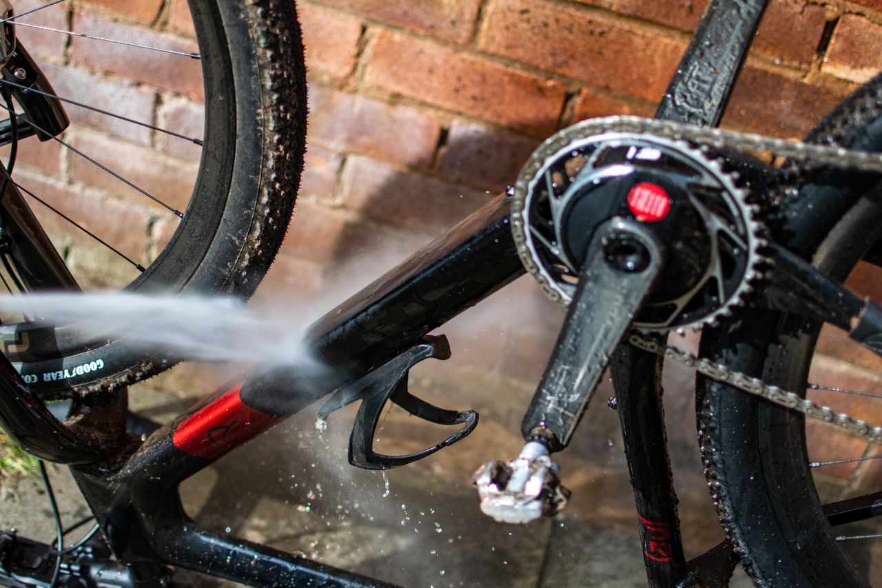 A Karcher Pressure washer spraying a bikes down tube