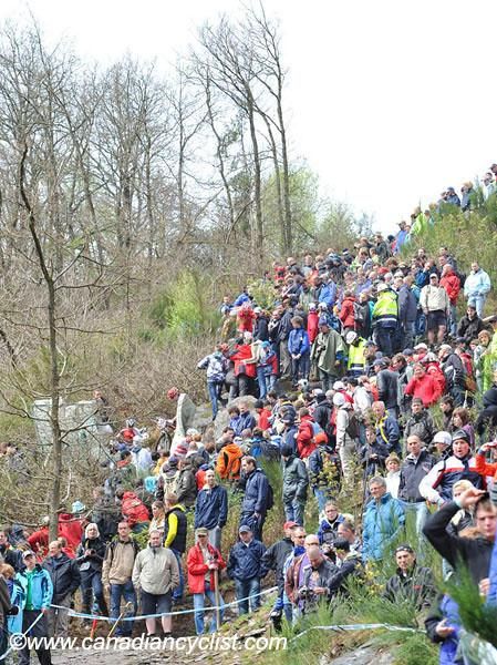 The crowds watch riders descend.