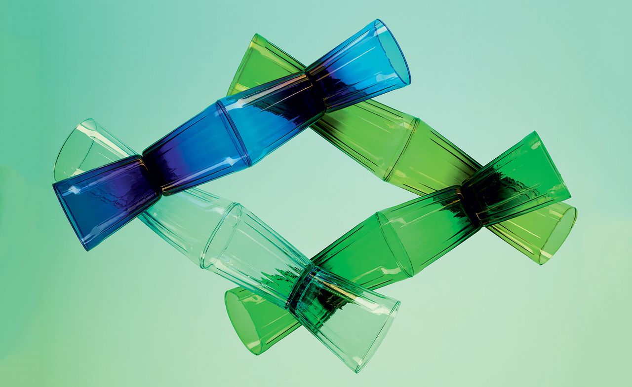 Tumblers in deep blue, and various shades of green on a gradient green background.