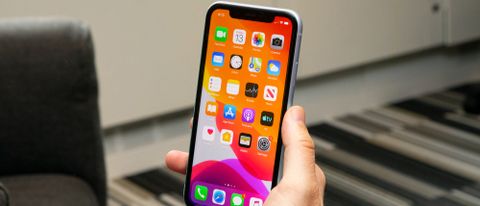 An iPhone 11 in someone's hand, with the screen on