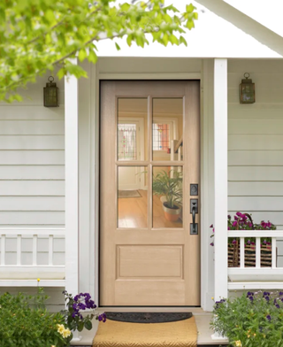 Farmhouse style front door with glass panels and porch