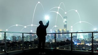 a person holding a wireless device and connecting to a wireless network