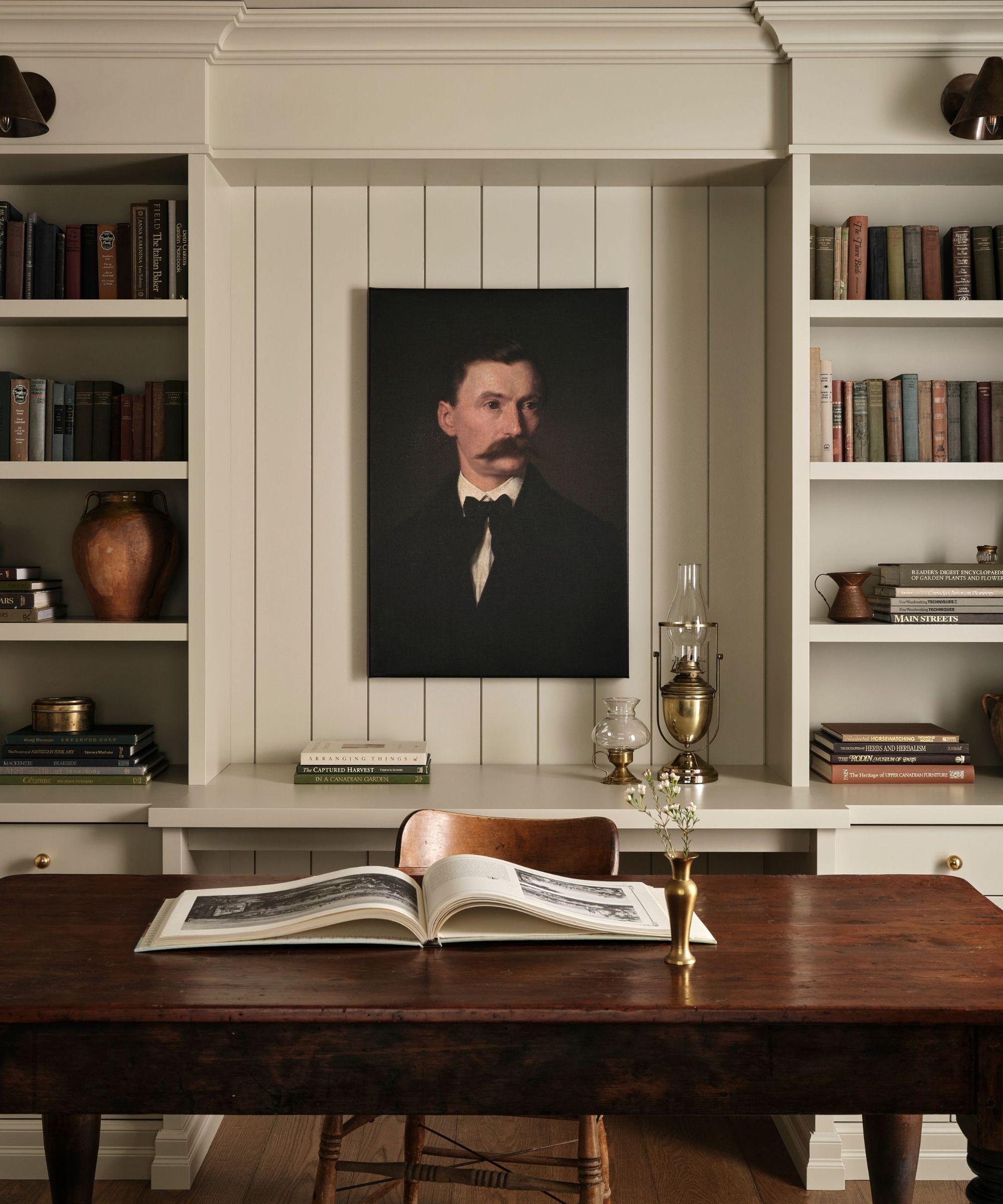 Home office with a vintage dark wood desk featuring a scalloped edge detail and turned legs