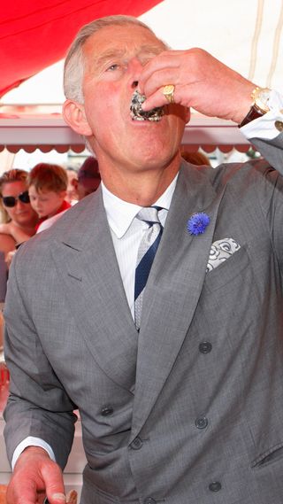 Prince Charles eating an oyster