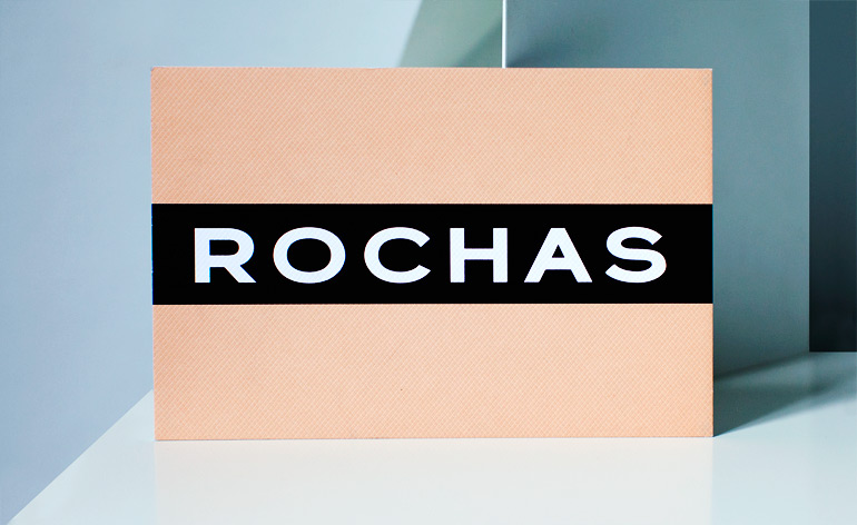A strip of black vinyl tape ran through the centre of Rochas' printed peach card