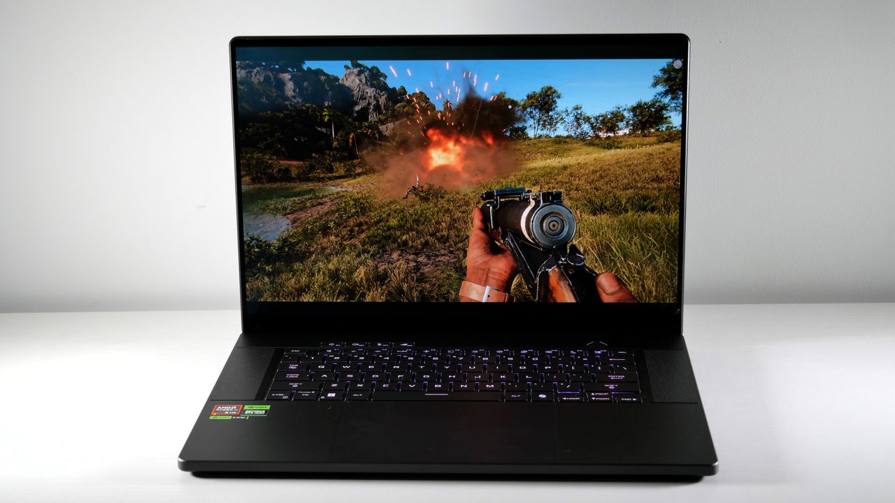 Asus ROG Zephyrus G16 (Ryzen AI 9) open on a white table with Far Cry 6 on screen.