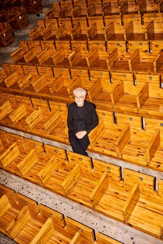 Marcio Kogan photographed in July by Eudes de Santana in the auditorium at São Paulo’s SESC Pompéia factory building, designed by Lina Bo Bardi in 1986