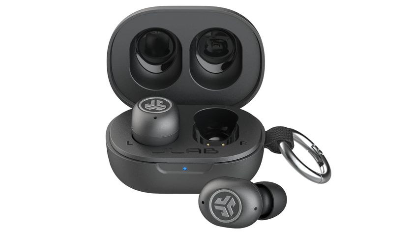 A black pair of JLabs JBuds Mini ANC wireless earbuds in their charging case on a white background.