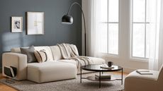 Modernize an outdated small living room to look like this blend of neutral furniture and dark gray and black accents