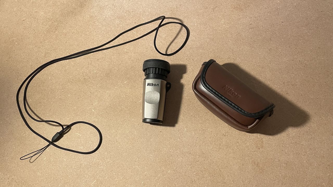Nikon 5x 15 HG Monocular next to its case