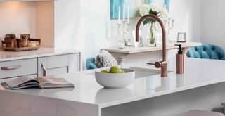 dove gray kitchen with rose gold taps and silver curved cabinets handles to highlight the kitchen trend 2023 of kitchen jewelry