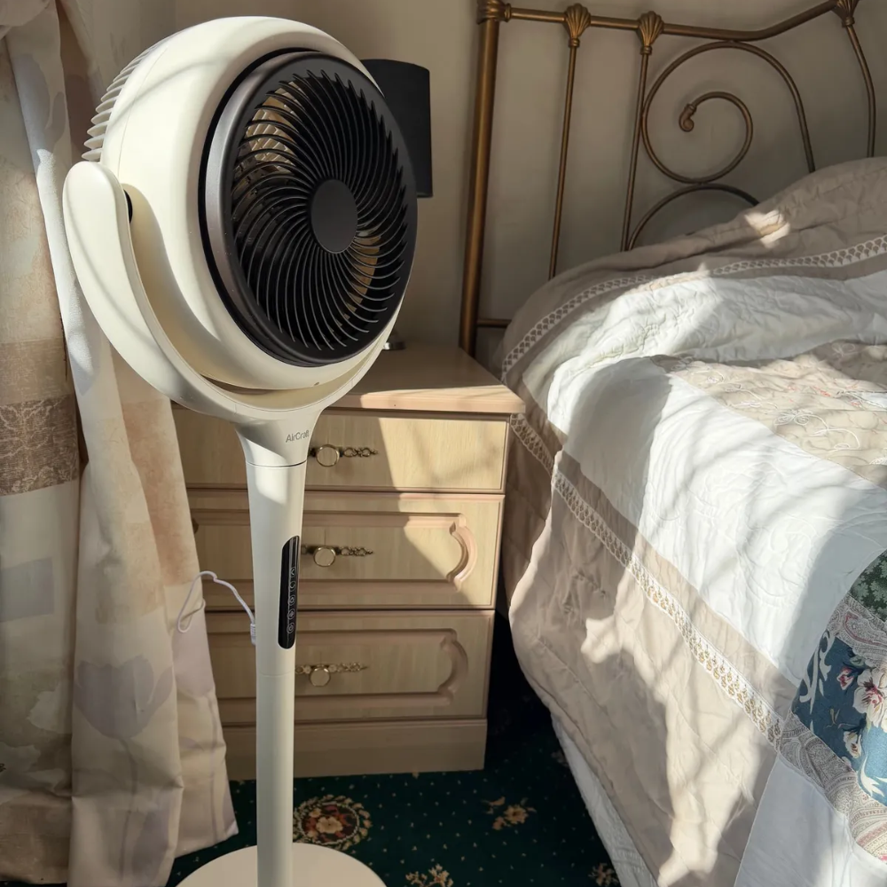 LUME Quiet Air Circulator Fan next to a bed