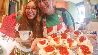 Two women serving tea and scones at a bike race