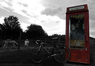 The machine sits beside a classic British phonebooth.
