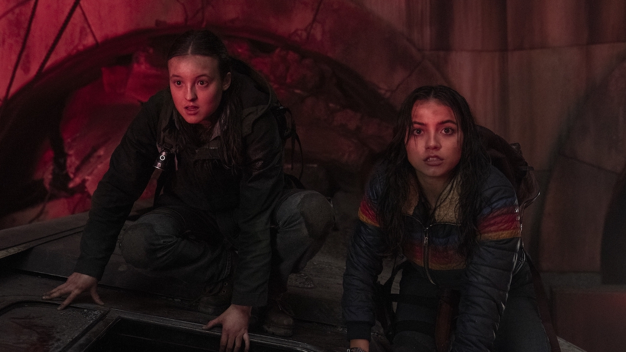Ellie and Dina in flare-lit subway station in The Last of Us Season 2 "Day One"