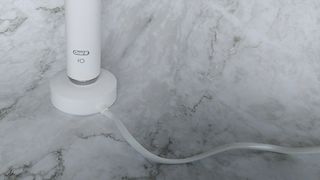 Oral-B iO Series 9 electric toothbrush on its charging base