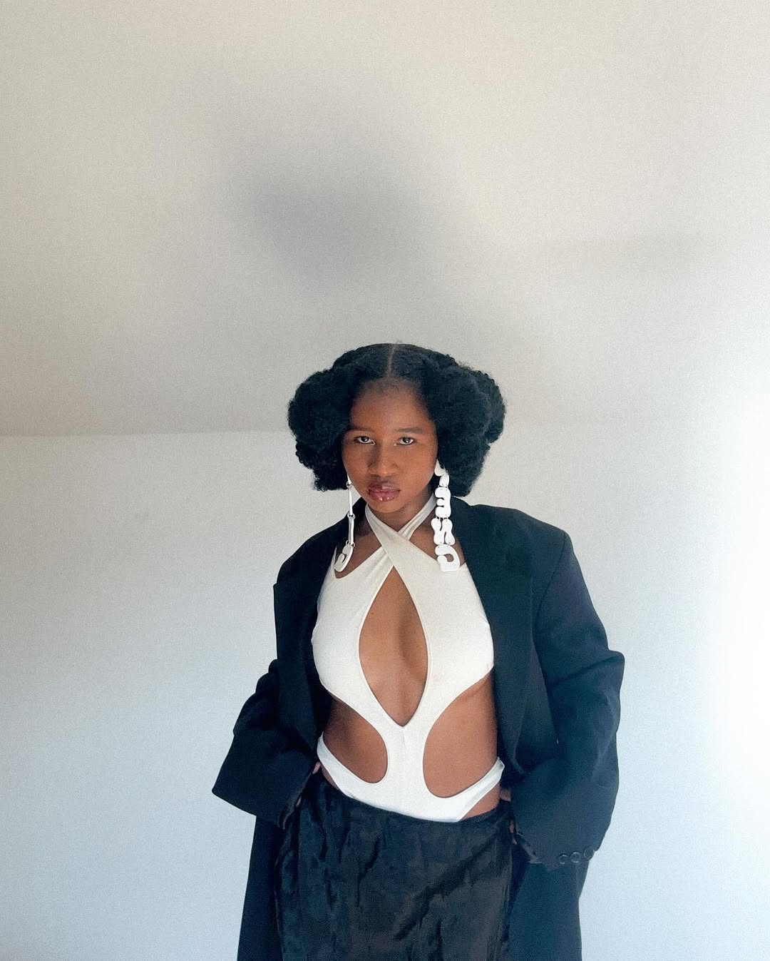 woman with cut-out shirt and short hair