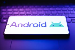 The Android logo appears on a smartphone screen in this photo illustration.