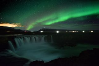 TOPSHOT - The aurora borealis, also known as Northern Lights, is seen over Godafoss waterfall, in the municipality of Thingeyjarsveit, east of Akureyri, in northern Iceland on October 14, 201