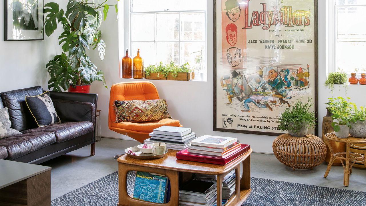 Mid-century styled living room with open coffee table, movie poster and rounded orange armchair