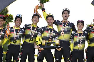 Belgian Tiesj Benoot of Team Visma-Lease a Bike, British Simon Philip Yates of Team Visma-Lease a Bike, American Sepp Kuss of Team Visma-Lease a Bike, Belgian Victor Campenaerts of Team Visma-Lease a Bike, Belgian Wout van Aert of Team Visma-Lease a Bike and Danish Jonas Vingegaard Hansen of Team Visma-Lease a Bike celebrate on the podium for winning the best team award after stage 21 of the 2025 Tour de France cycling race, from Mantes-la-Ville to Paris (120km), on Sunday 27 July 2025 in France. The 112th edition of the Tour de France starts on Saturday 5 July in Lille, France, and will finish in Paris, France on the 27th of July. BELGA PHOTO JASPER JACOBS (Photo by JASPER JACOBS / BELGA MAG / Belga via AFP)