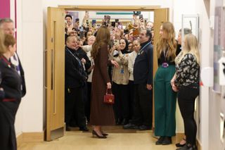 Princess Kate at a hospital carrying a red bag by Asprey of London