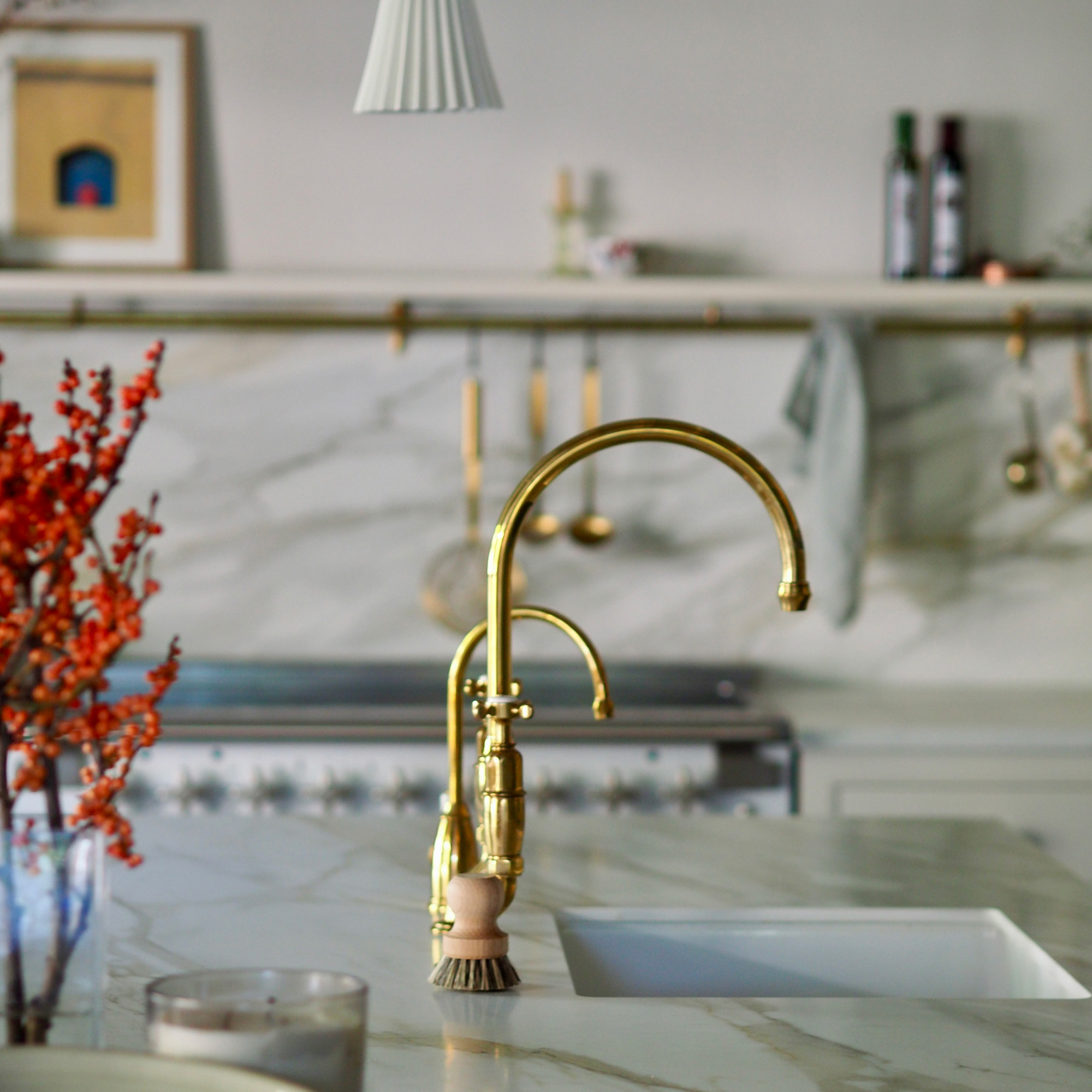 kitchen with neutral white walls and cabinetry and island with dark wood flooring and unpainted wooden unit cabinets