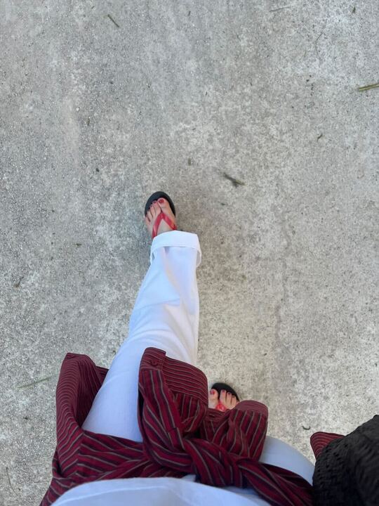 Seo writer Ava wears Ancient Greek Sandals a white jeans a white shirt and dark red shirt.