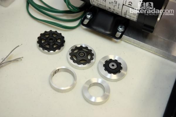 Different machined aluminum clamps are used for different pulley diameters.