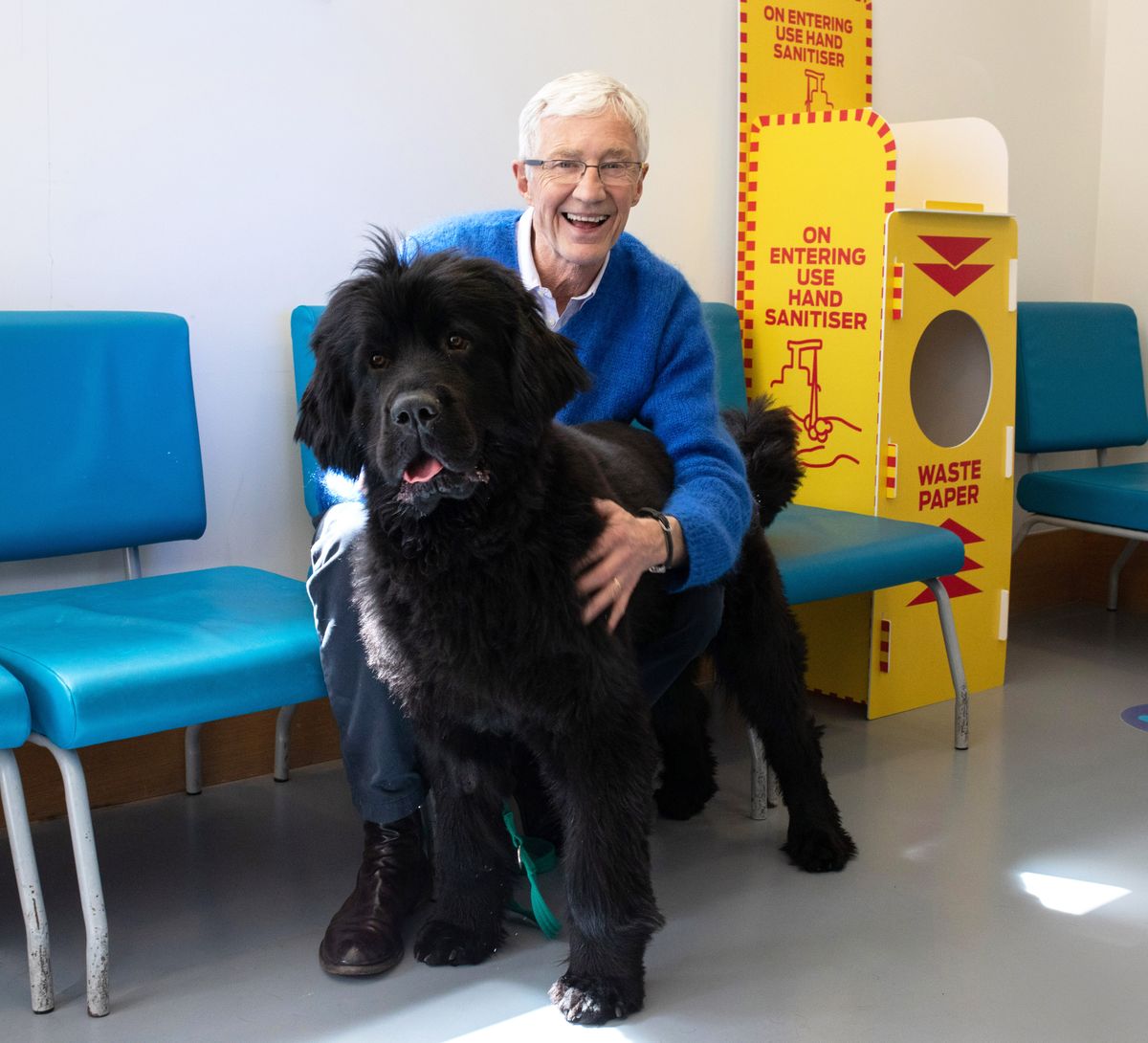 Paul O&#039;Grady poses with Peggy, a large black Newfoundland, at Battersea Dogs &amp; Cats Home