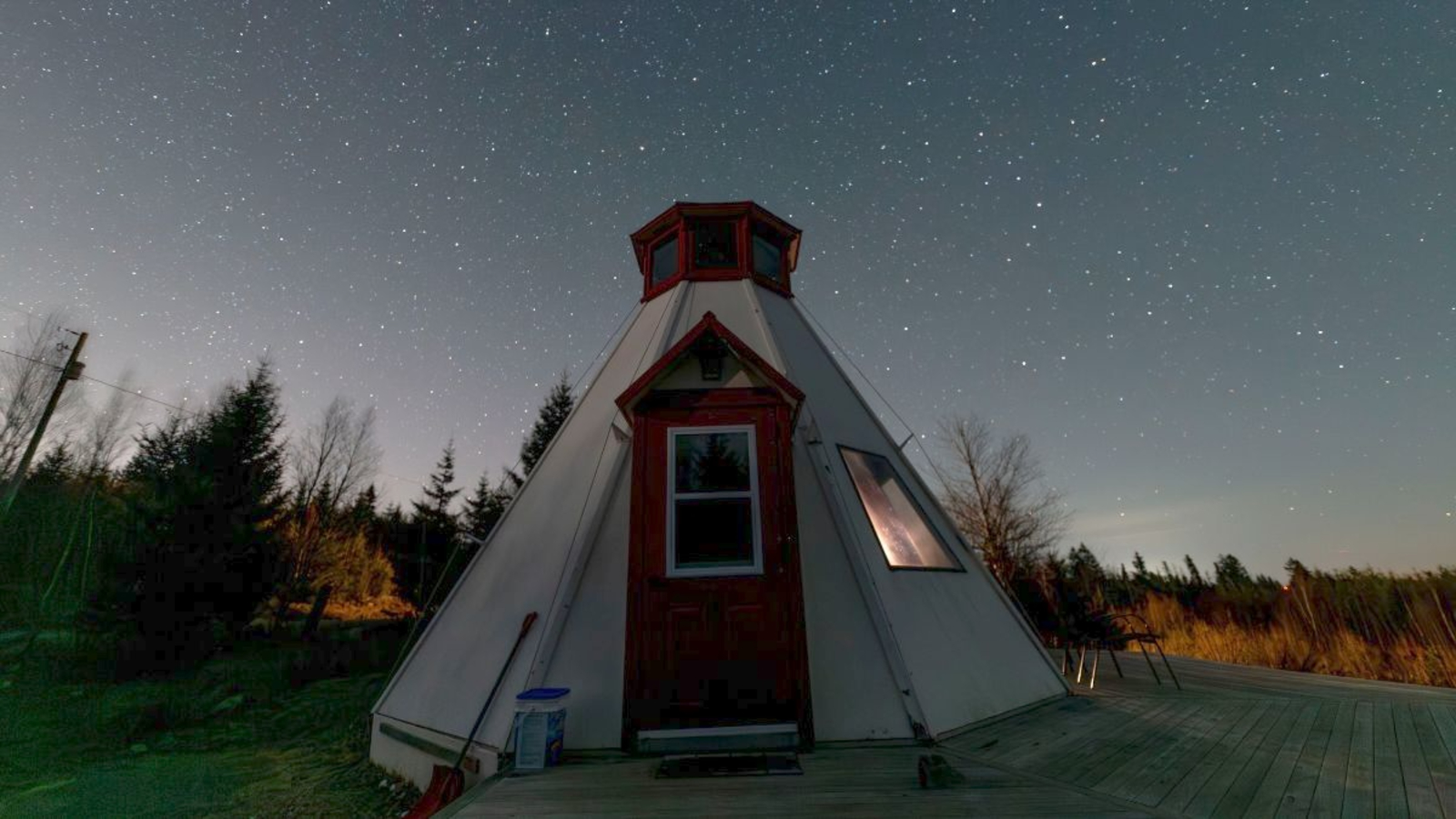 A tent sits under the night sky watching the stars