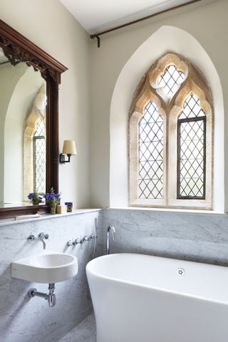 bathroom in listed building with arched windows