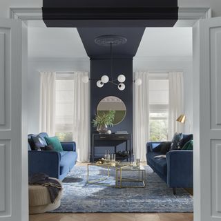 A living room with a black strip of paint from the ceiling to the wall