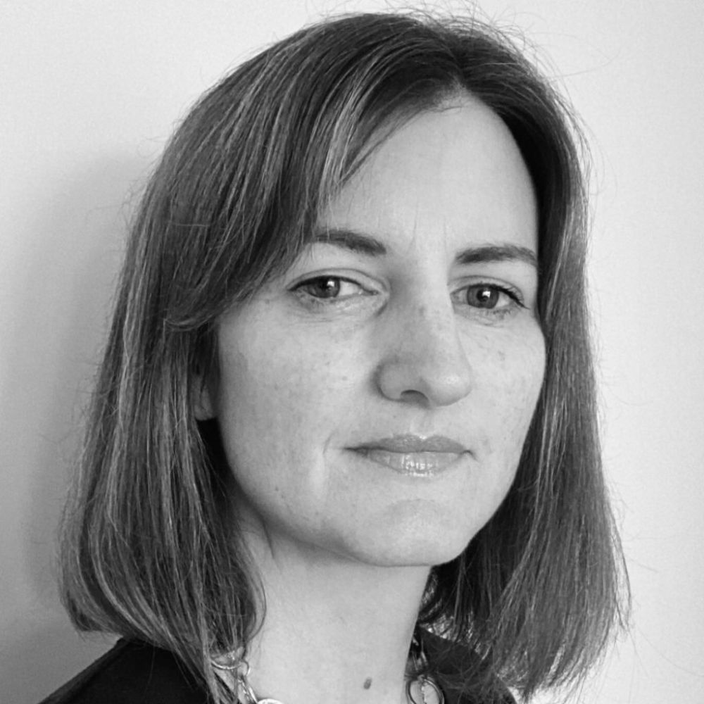Black and white professional headshot of a woman with shoulder length hair