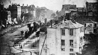 An old photo of a deserted 19th century street