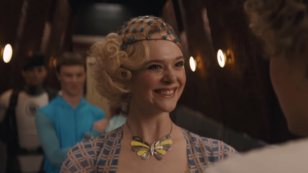 Elle Fanning smiling at Effie Trinket in the Sunrise on the Reaping teaser