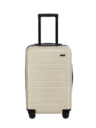 A beige carry-on suitcase with a hard shell