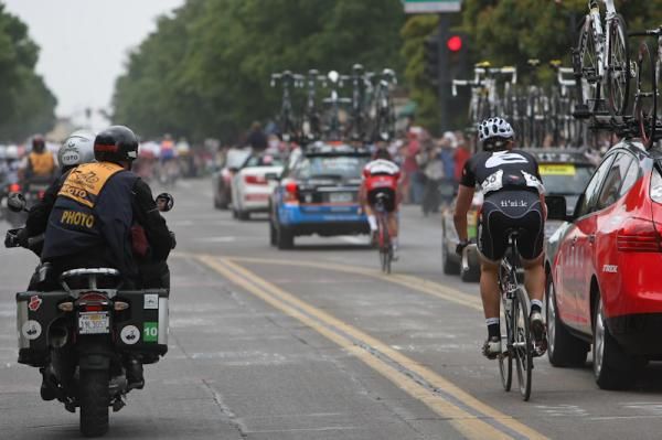 Cervelo's Dominique Rollin rides next to the RadioShack team car.