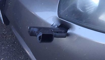 Driver surprised to find a gun stuck in his vehicle's front bumper