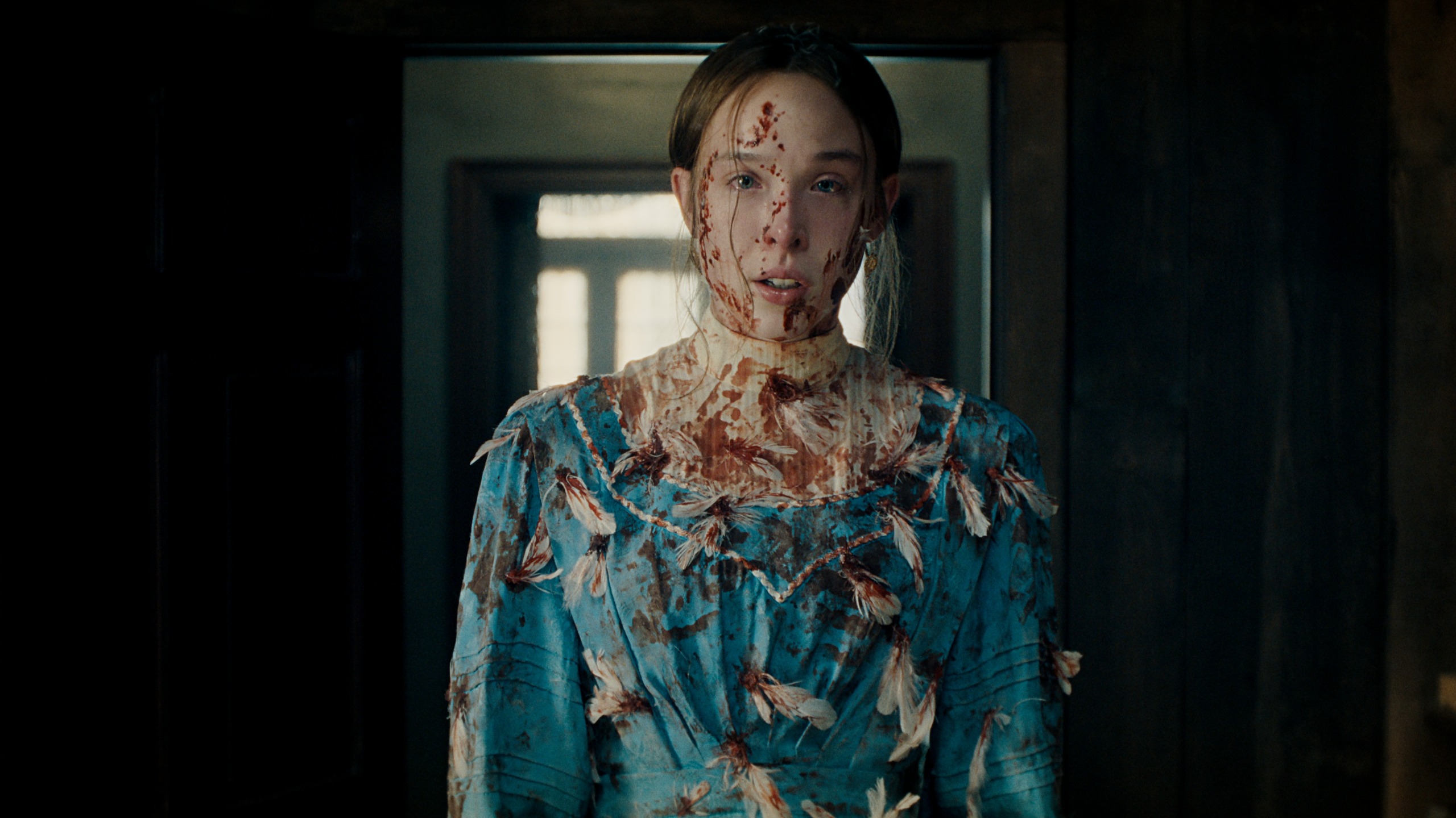 Ella Beatty as Lizzie Borden covered in blood and feathers.