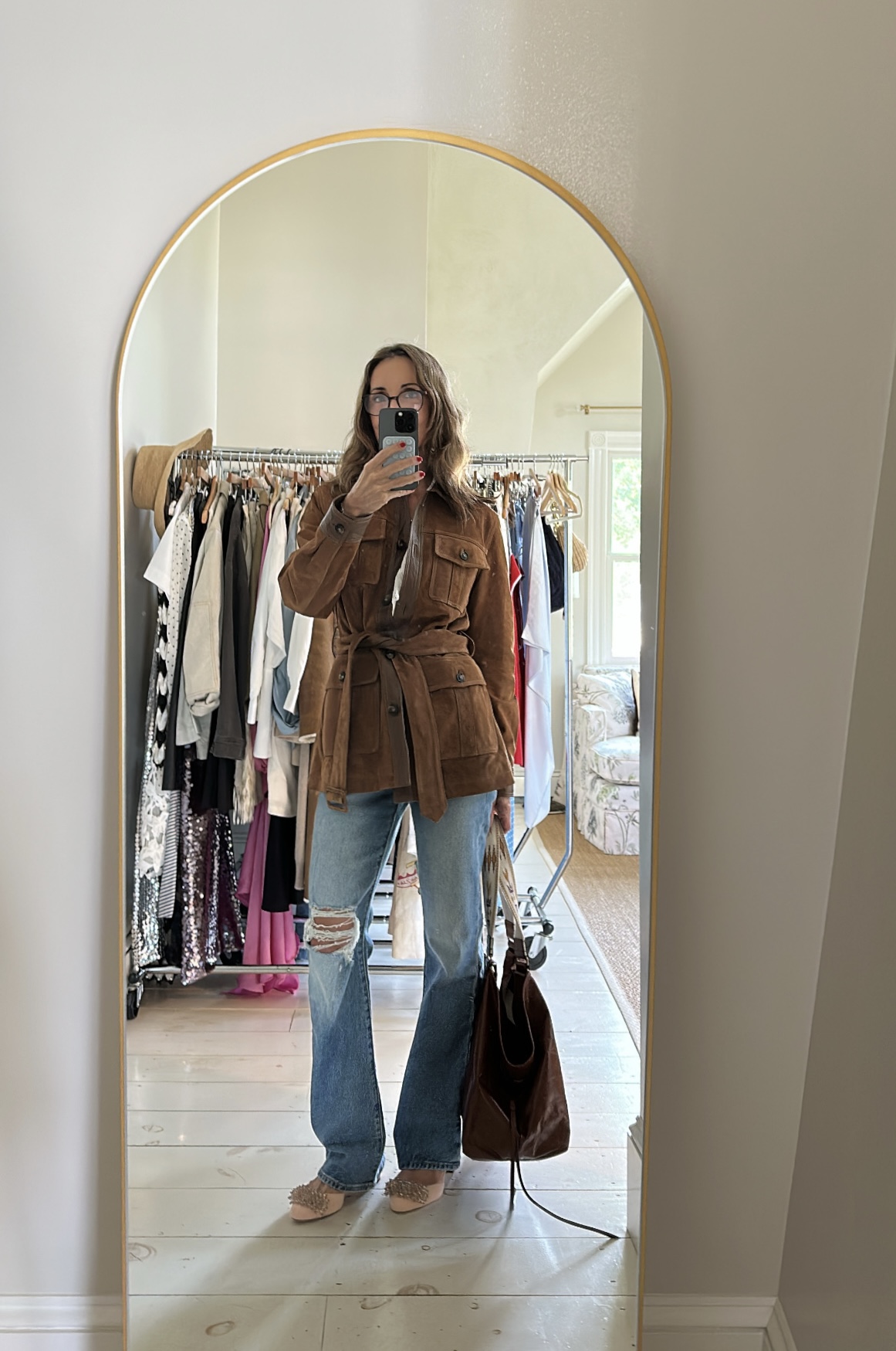 Larissa Mills wearing blue jeans and a brown suede blazer